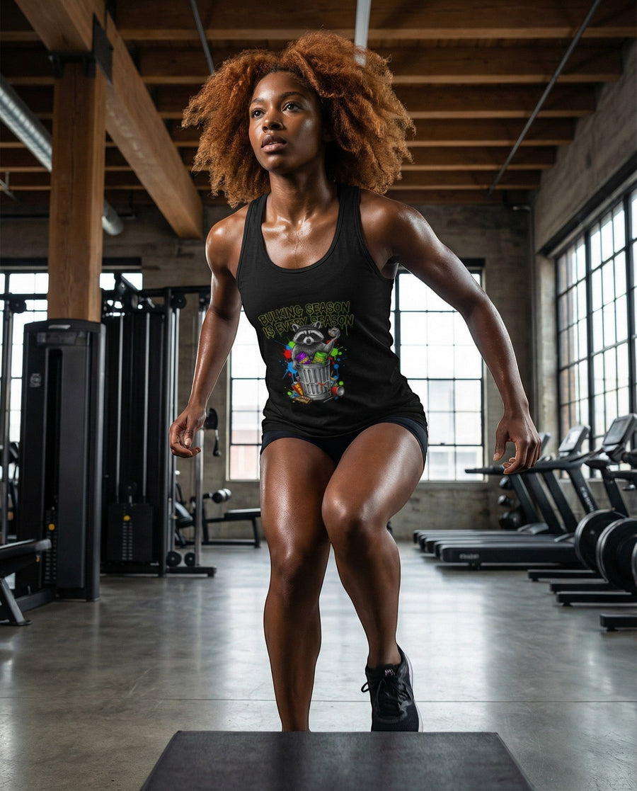 DailyThreadCo. black cotton racerback tank top with a funny graphic of a raccoon in a trash can saying "Bulking season is every season".