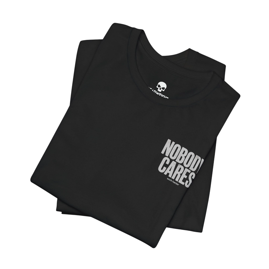 DailyThreadCo. black cotton graphic t-shirt with Nobody Cares Work Harder text print, folded on a black background.