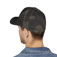 DailyThreadCo. camo Flexfit cap worn by a man in a denim jacket, featuring a structured six-panel design.