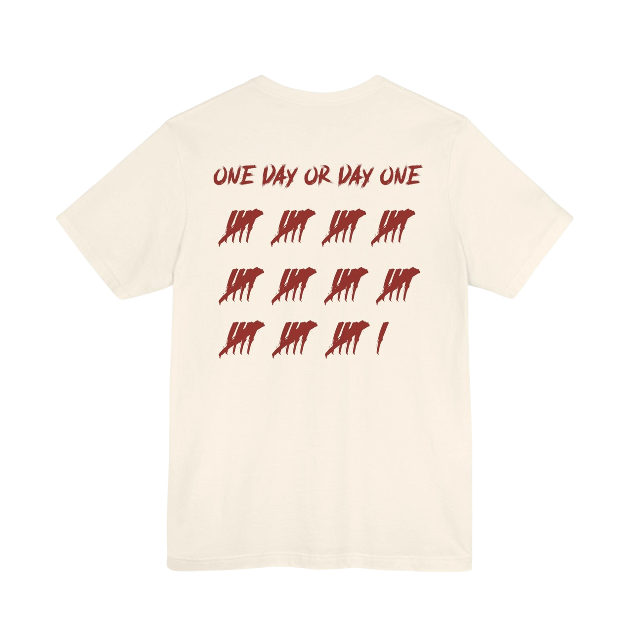 DailyThreadCo. cream cotton t-shirt featuring a red One Day or Day One graphic with tally marks on the back.