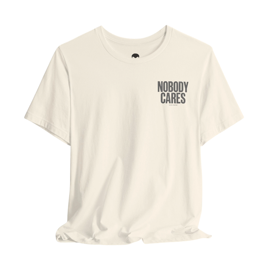DailyThreadCo. cream cotton graphic tee with Nobody Cares text on the chest, featuring a crew neck and retail fit.