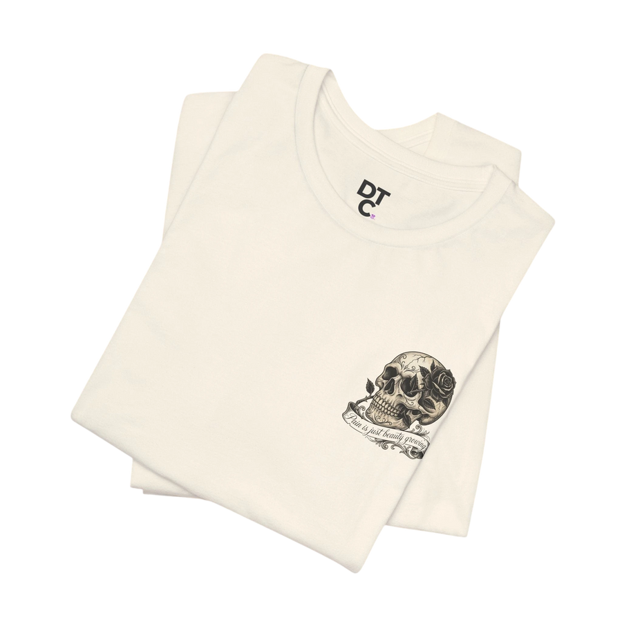 DailyThreadCo. cream 100% cotton graphic tee with skull and rose artwork on chest. Crew neck, short sleeves.