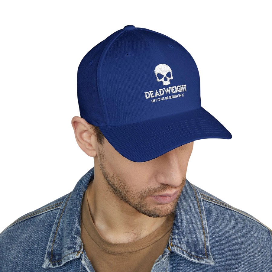 DailyThreadCo. blue structured Flexfit cap with white distressed skull embroidery and text on a model.