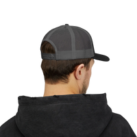 DailyThreadCo. Deadweight skull trucker cap with breathable mesh back and adjustable snapback worn by a man.