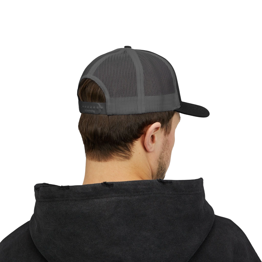 DailyThreadCo. Deadweight skull trucker cap with breathable mesh back and adjustable snapback worn by a man.