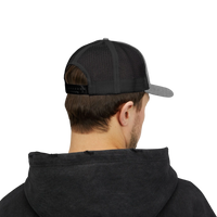 DailyThreadCo. Deadweight skull trucker cap with black mesh back, grey front panels, and adjustable snapback closure.
