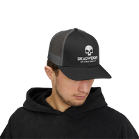 DailyThreadCo. black and grey trucker cap with skull logo, worn by a man in a black hoodie for gym or casual wear.