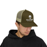 DailyThreadCo. olive green and tan trucker cap with white skull Deadweight logo worn by a man in a black hoodie.