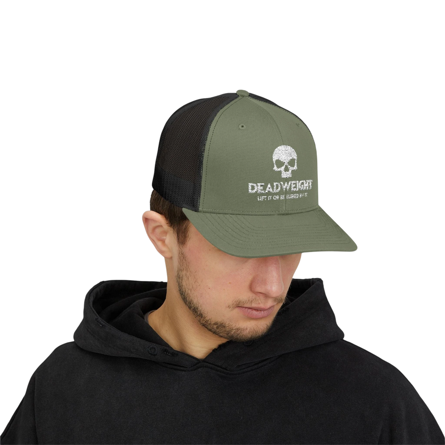 DailyThreadCo. olive green and black trucker cap with white skull Deadweight logo worn by a man in a black hoodie.