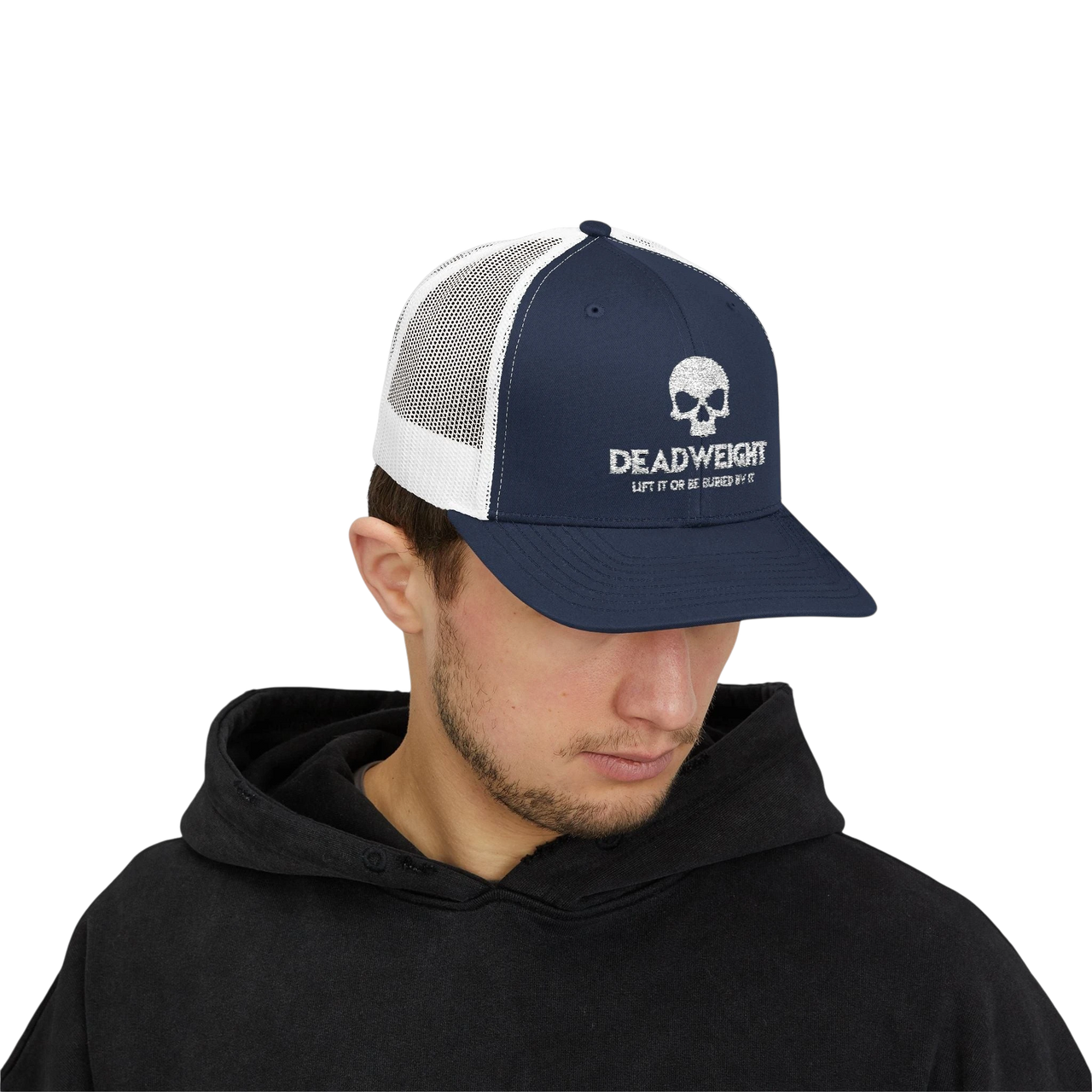 DailyThreadCo. navy blue and white trucker cap with skull logo, worn by a man in a black hoodie.