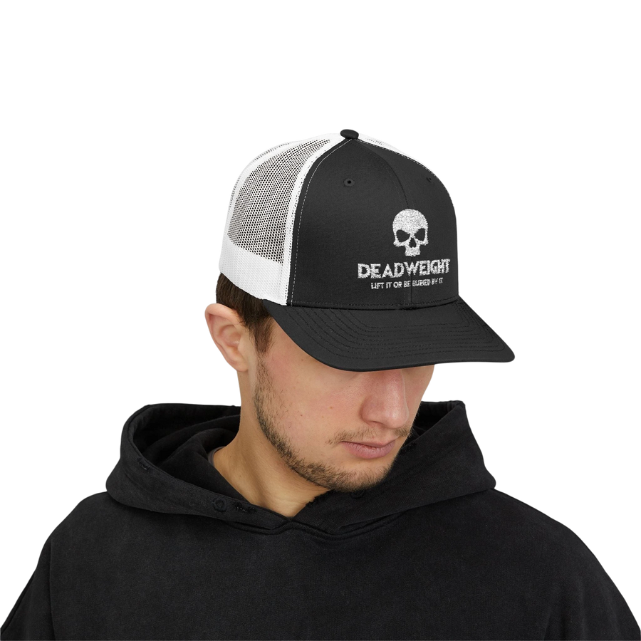DailyThreadCo. black and white trucker cap with skull logo, worn by a man in a black hoodie for gym and fitness.