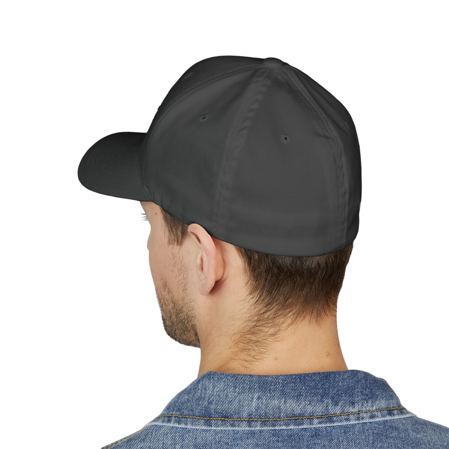 DailyThreadCo. structured flexfit cap in dark grey with a curved visor, worn by a man in a denim jacket.