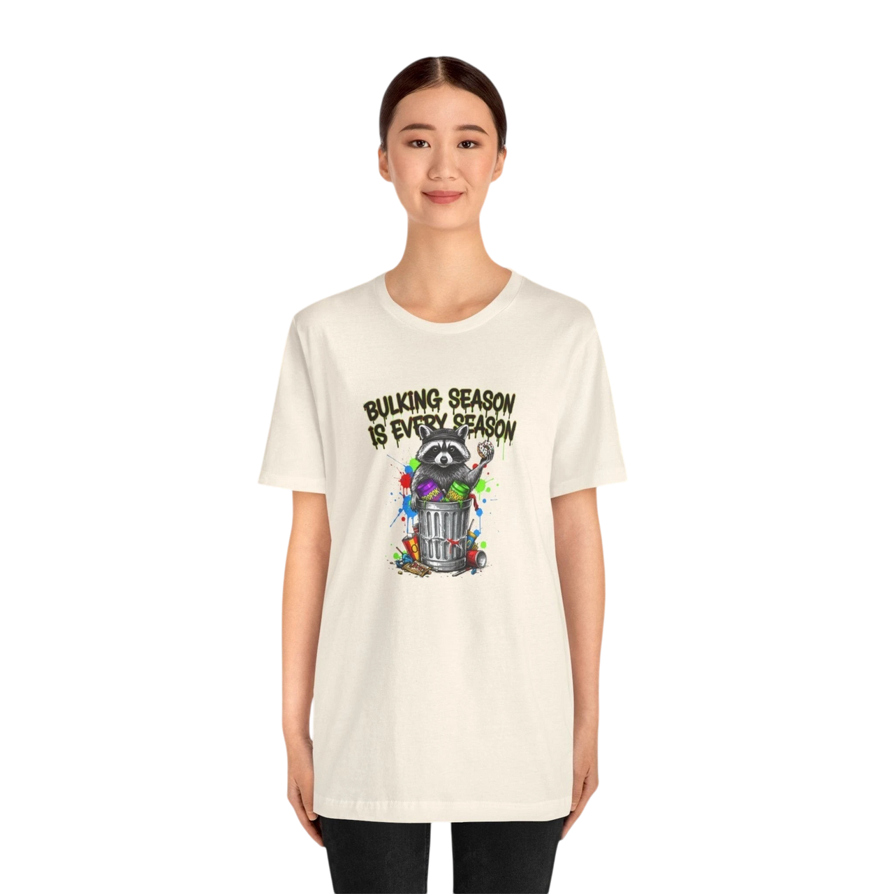DailyThreadCo. cream 100% cotton t-shirt with a graphic of a raccoon in a trash can, text reads "BULKING SEASON IS EVERY SEASON".