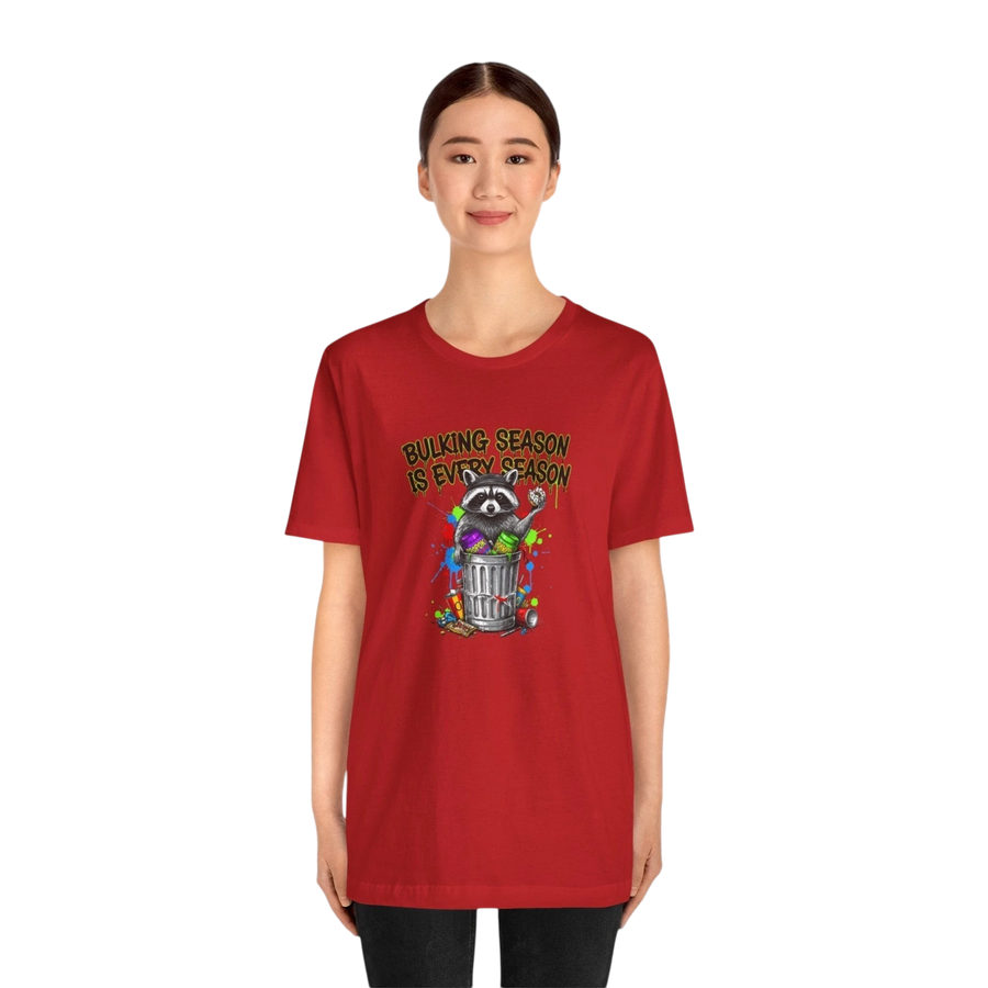 DailyThreadCo. red 100% cotton t-shirt with a graphic of a raccoon in a trash can with the text "BULKING SEASON IS EVERY SEASON".