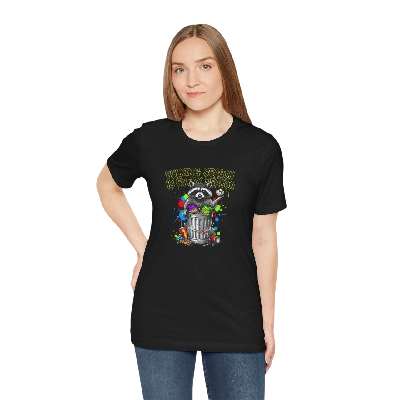 DailyThreadCo. black 100% cotton t-shirt with a funny graphic of a raccoon in a trash can, surrounded by colorful paint splatters and the text "BULKING SEASON IS EVERY SEASON".