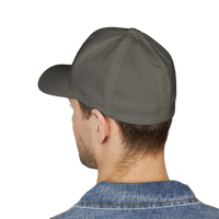 DailyThreadCo. structured flexfit cap in grey with a mid-profile fit, worn by a man against a black background.