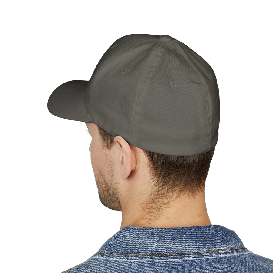 DailyThreadCo. structured flexfit cap in grey with a mid-profile fit, worn by a man against a black background.