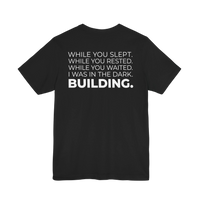 DailyThreadCo. black cotton t-shirt featuring a bold motivational typographic print on the back.