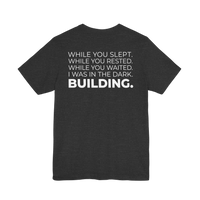 DailyThreadCo. charcoal grey motivational t-shirt with white typographic back print about building in the dark.
