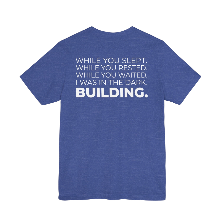 DailyThreadCo. blue heathered cotton t-shirt featuring a motivational typographic back print about building in silence.