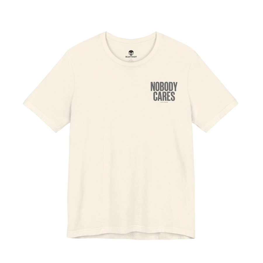 DailyThreadCo. Nobody Cares graphic tee in cream cotton with black chest text, featuring a crew neck and retail fit.