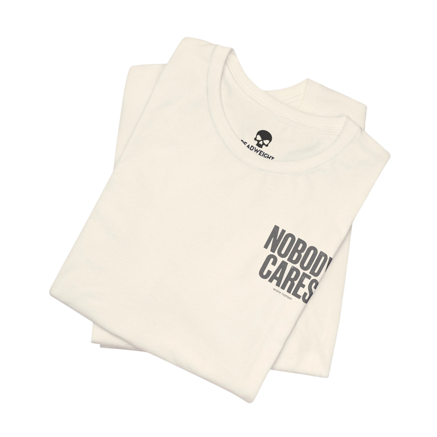 DailyThreadCo. Nobody Cares graphic tee in cream cotton with black text, featuring a crew neck and retail fit.