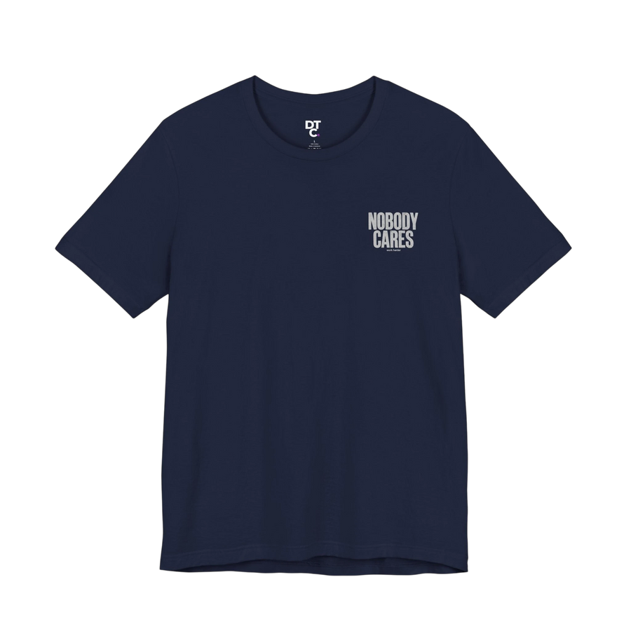 DailyThreadCo. navy blue 100% cotton graphic tee with "Nobody Cares" text art on the chest.
