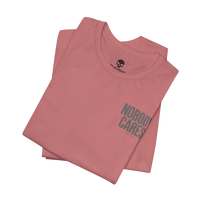 DailyThreadCo. Nobody Cares graphic tee in dusty pink cotton with a crew neck and minimalist front text design.