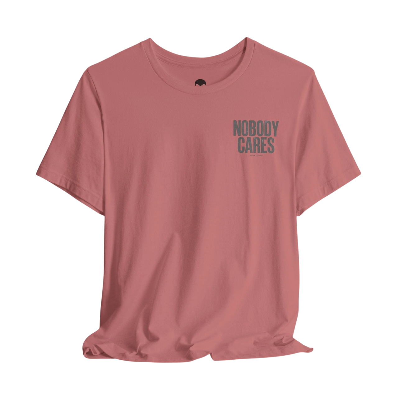 DailyThreadCo. Nobody Cares graphic tee in dusty rose cotton with a minimalist chest print and crew neckline.