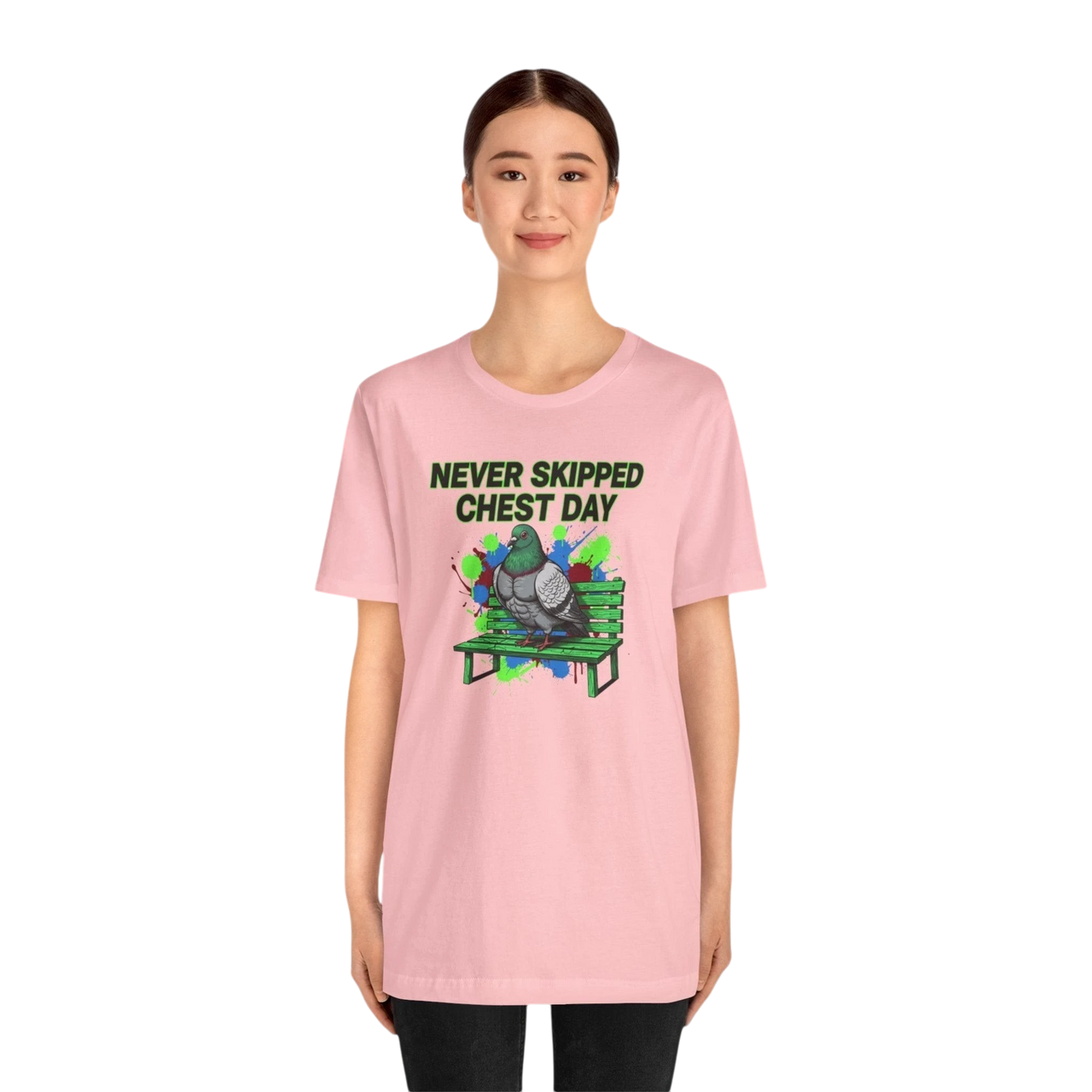 DailyThreadCo. pink cotton t-shirt with a graphic of a pigeon on a bench and the text "NEVER SKIPPED CHEST DAY".