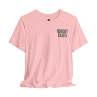 DailyThreadCo. light pink cotton graphic t-shirt featuring Nobody Cares text on the chest in a retail fit.