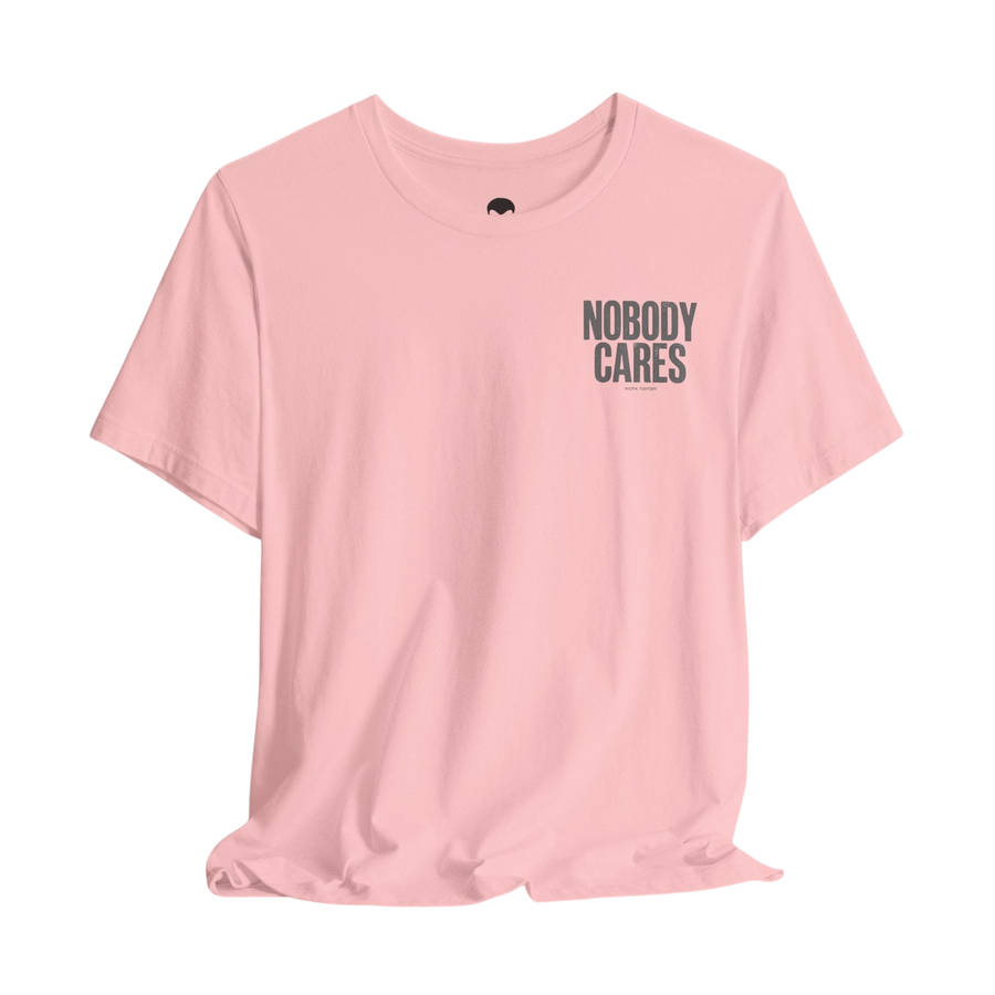 DailyThreadCo. light pink cotton graphic t-shirt featuring Nobody Cares text on the chest in a retail fit.