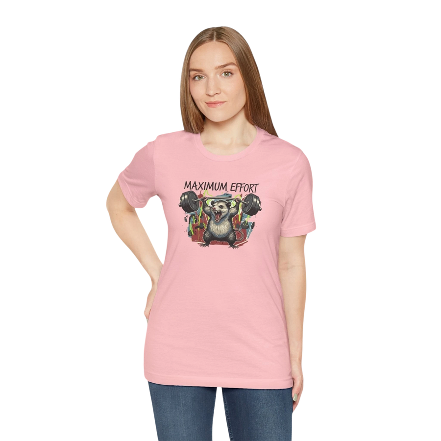 DailyThreadCo. pink 100% cotton t-shirt with a graphic of a possum lifting a barbell and the text "MAXIMUM EFFORT".