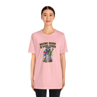 DailyThreadCo. pink cotton t-shirt with a graphic of a raccoon in a trash can with the text 