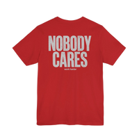 DailyThreadCo. red graphic t-shirt with Nobody Cares Work Harder text in distressed white print on the back.