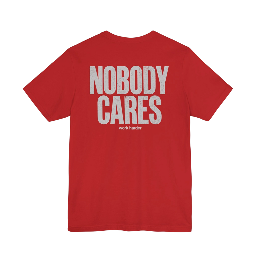 DailyThreadCo. red graphic t-shirt with Nobody Cares Work Harder text in distressed white print on the back.