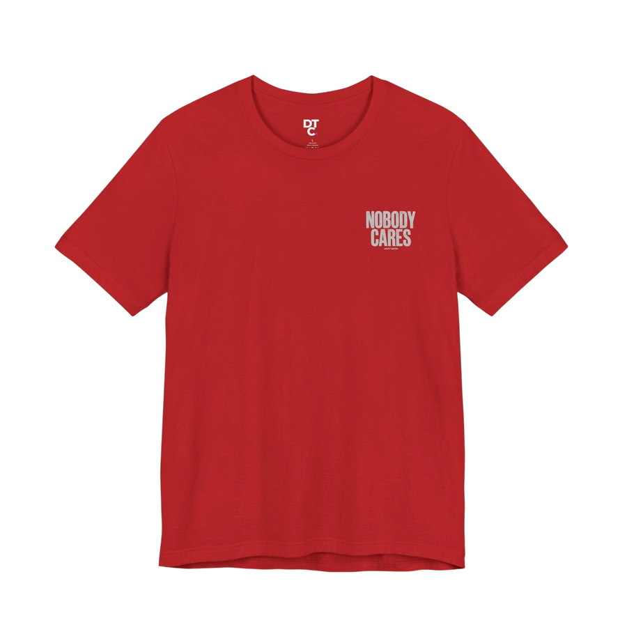 DailyThreadCo. red 100% cotton graphic tee with "Nobody Cares" text on the chest.