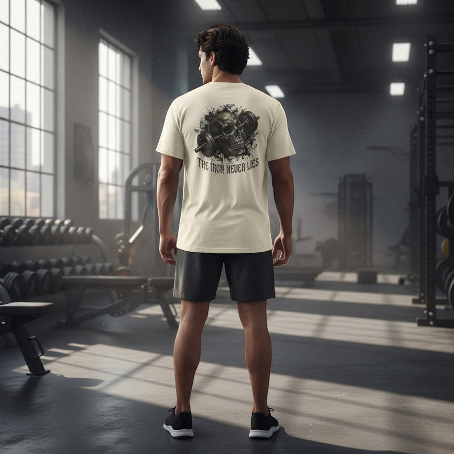 DailyThreadCo. cream cotton t-shirt with a graphic of a skull and barbell on the back, reading "The Iron Never Lies".