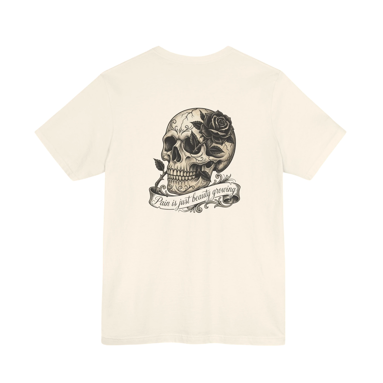 DailyThreadCo. cream 100% cotton graphic tee with a vintage skull and rose design, featuring the text "Pain is just beauty growing" on a banner.