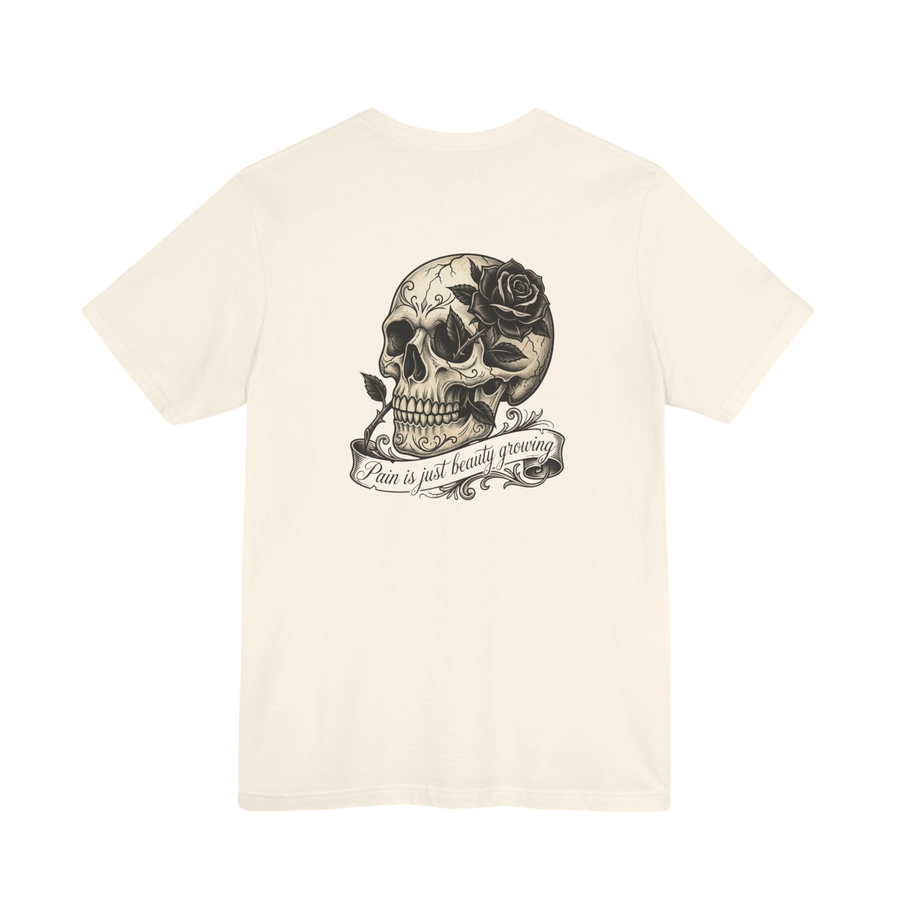 DailyThreadCo. cream 100% cotton graphic tee with a vintage skull and rose design, featuring the text "Pain is just beauty growing" on a banner.