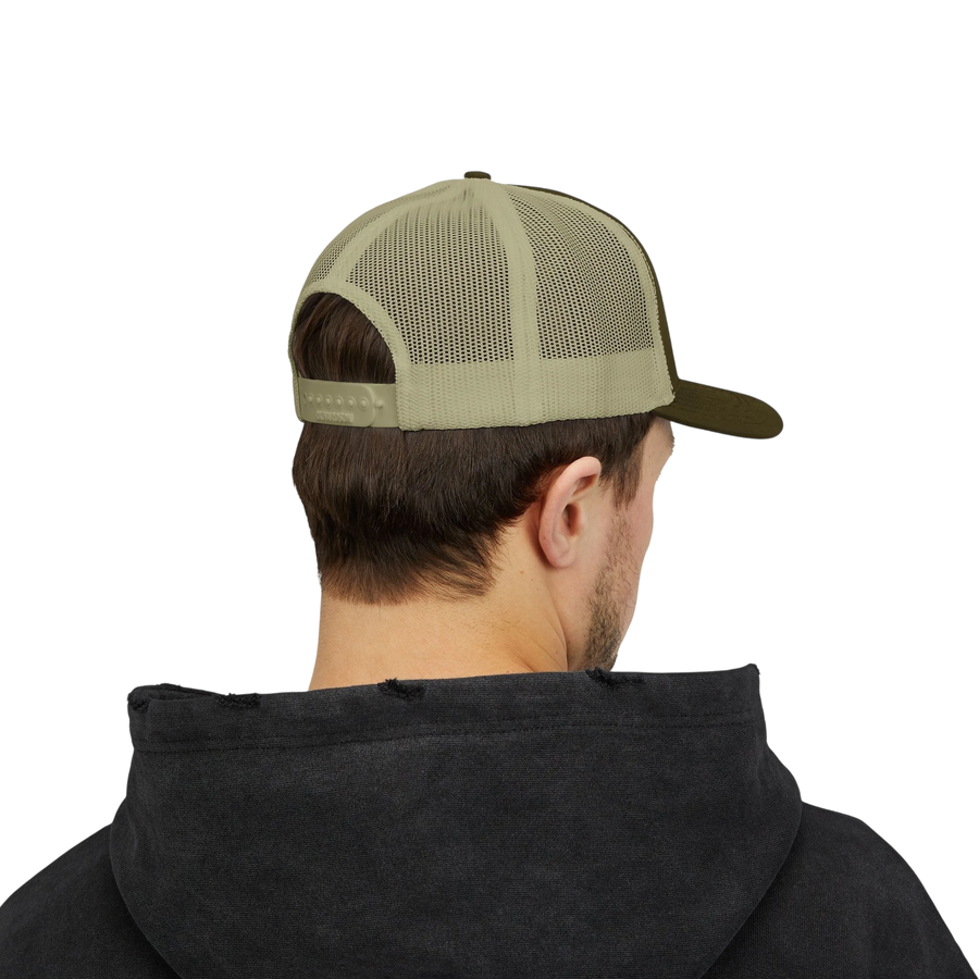 DailyThreadCo. olive green and tan mesh back trucker cap with adjustable snapback worn by a man in a black hoodie.
