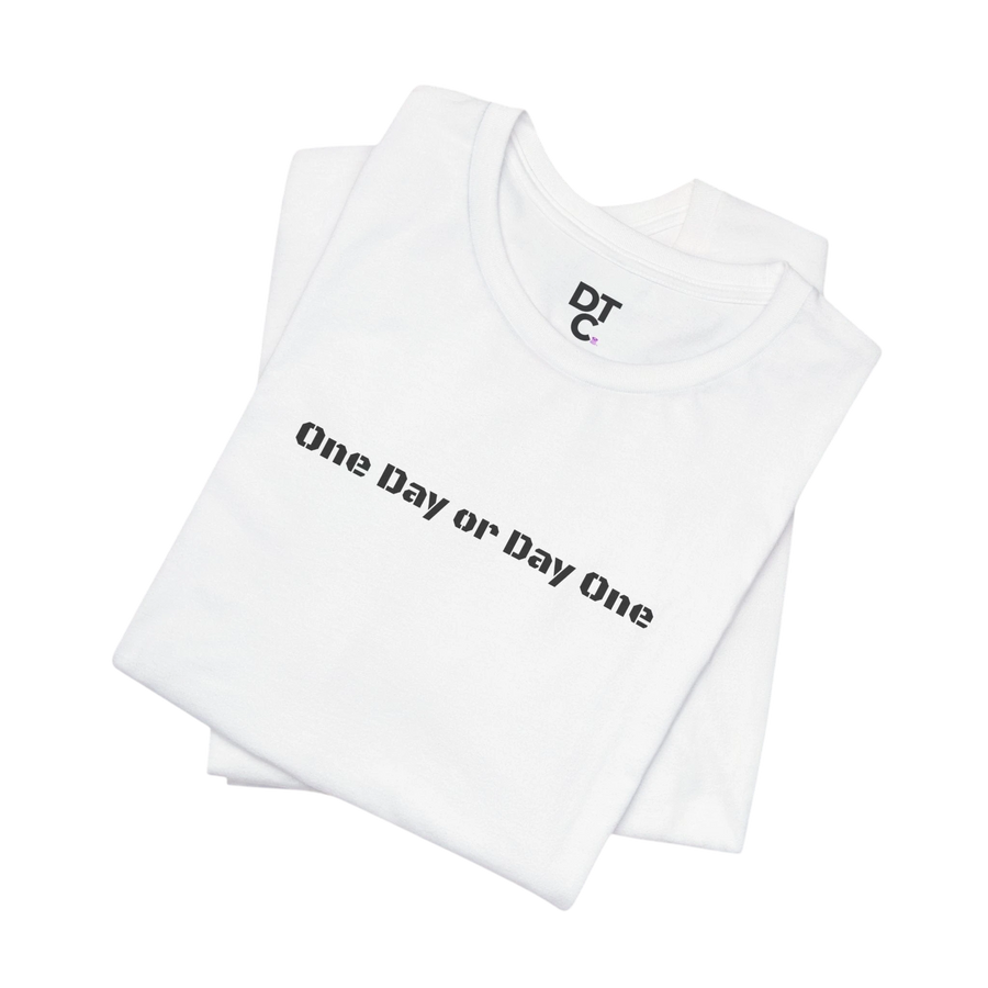 DailyThreadCo. white 100% cotton crew neck t-shirt with black "One Day or Day One" graphic.